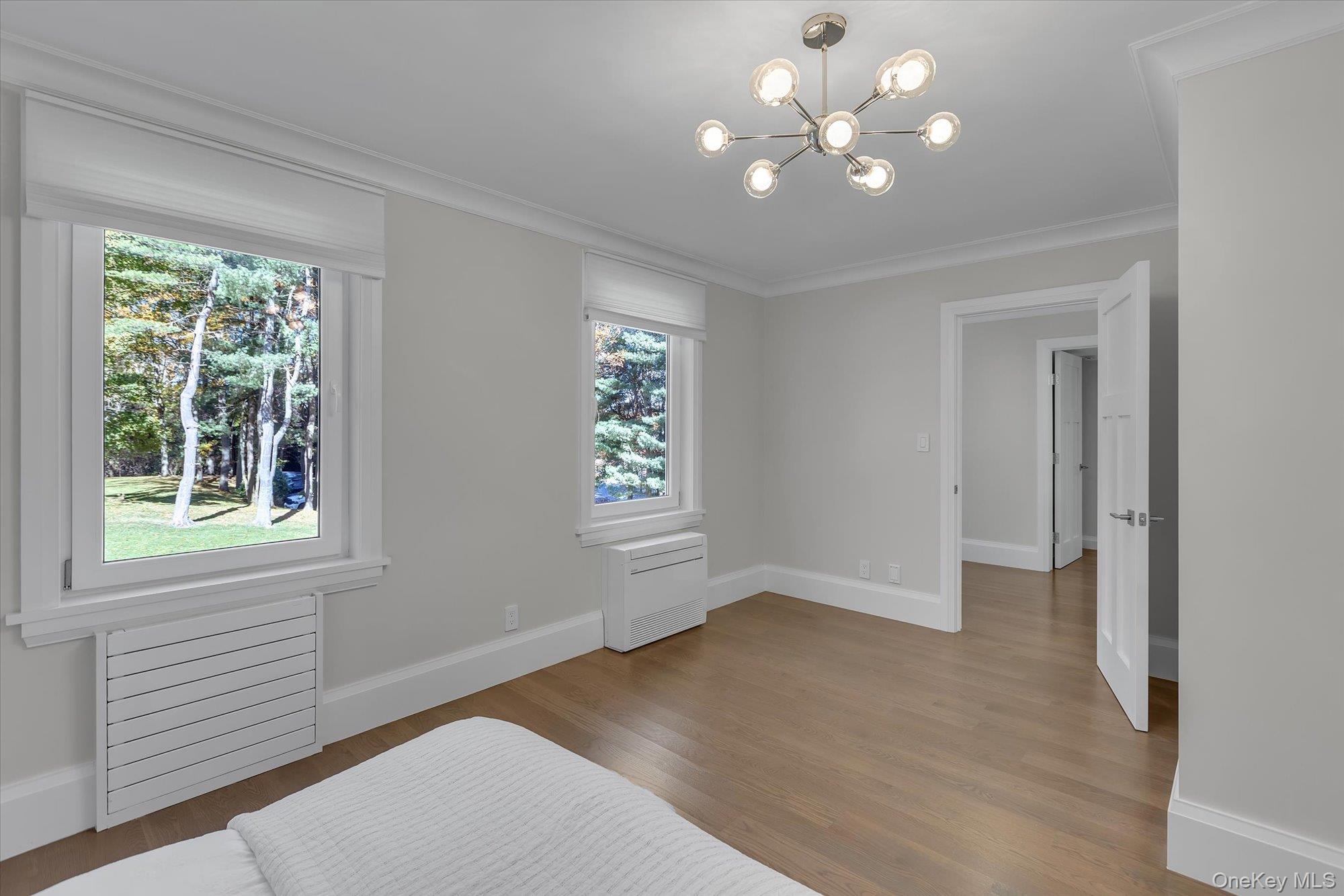 22 Fort Salonga Road Centerport, NY 11721 - Photo 29 of 42 a view of an empty room with a window and wooden floor