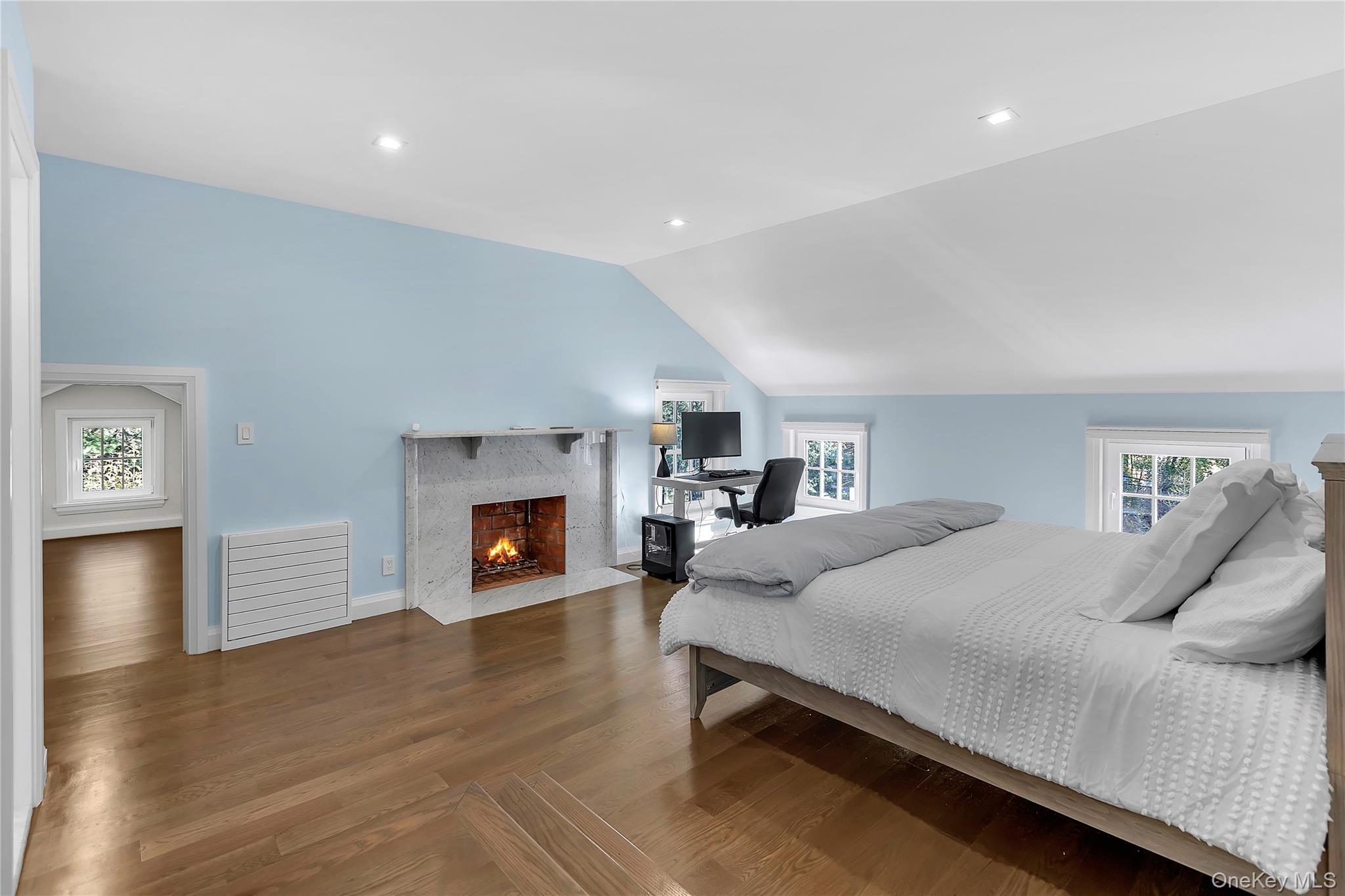 22 Fort Salonga Road Centerport, NY 11721 - Photo 32 of 42 a bedroom with a bed and a fireplace