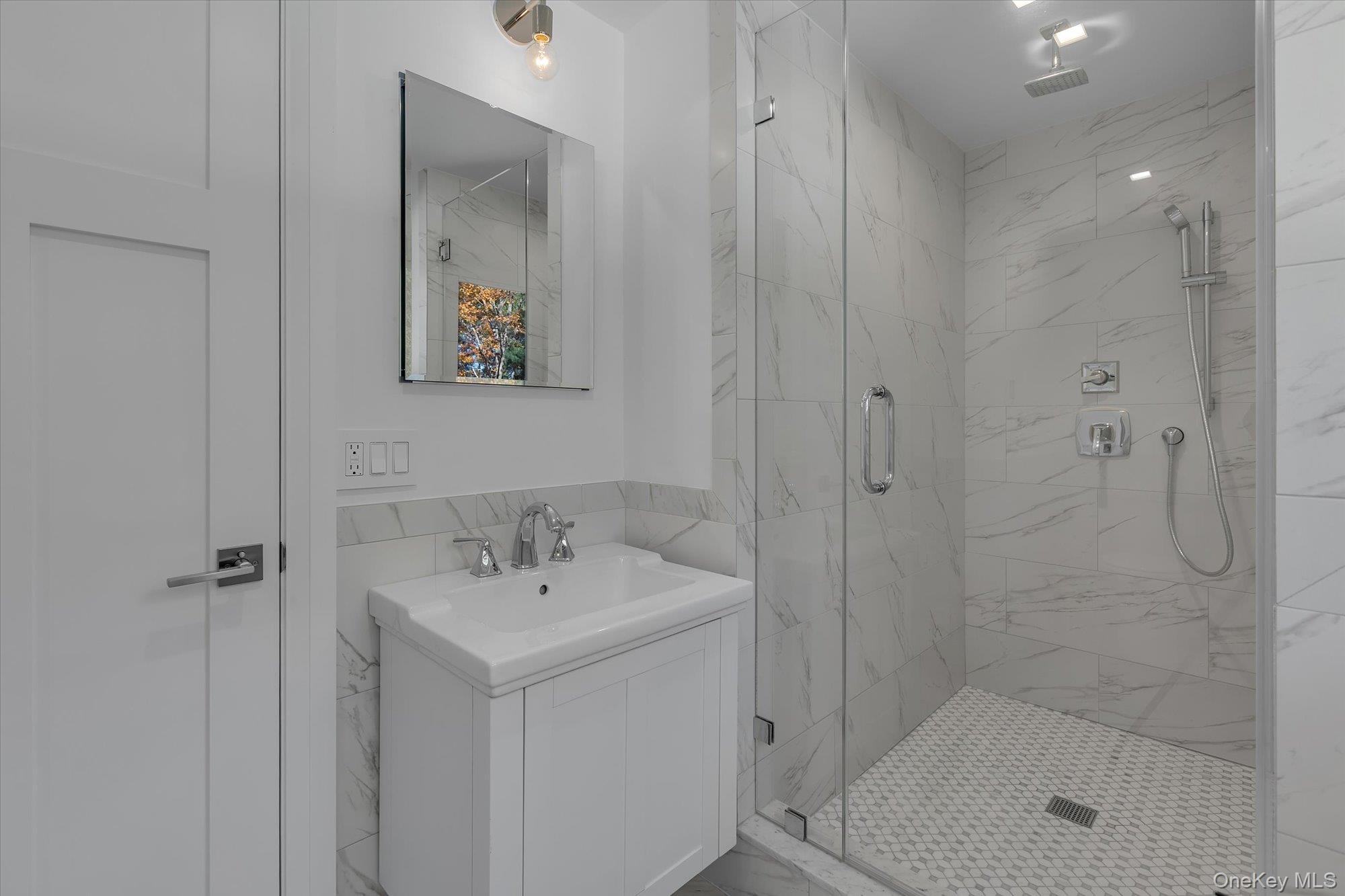 22 Fort Salonga Road Centerport, NY 11721 - Photo 34 of 42 Junior Ensuite Bathroom featuring vanity, a marble finish shower, and tile walls