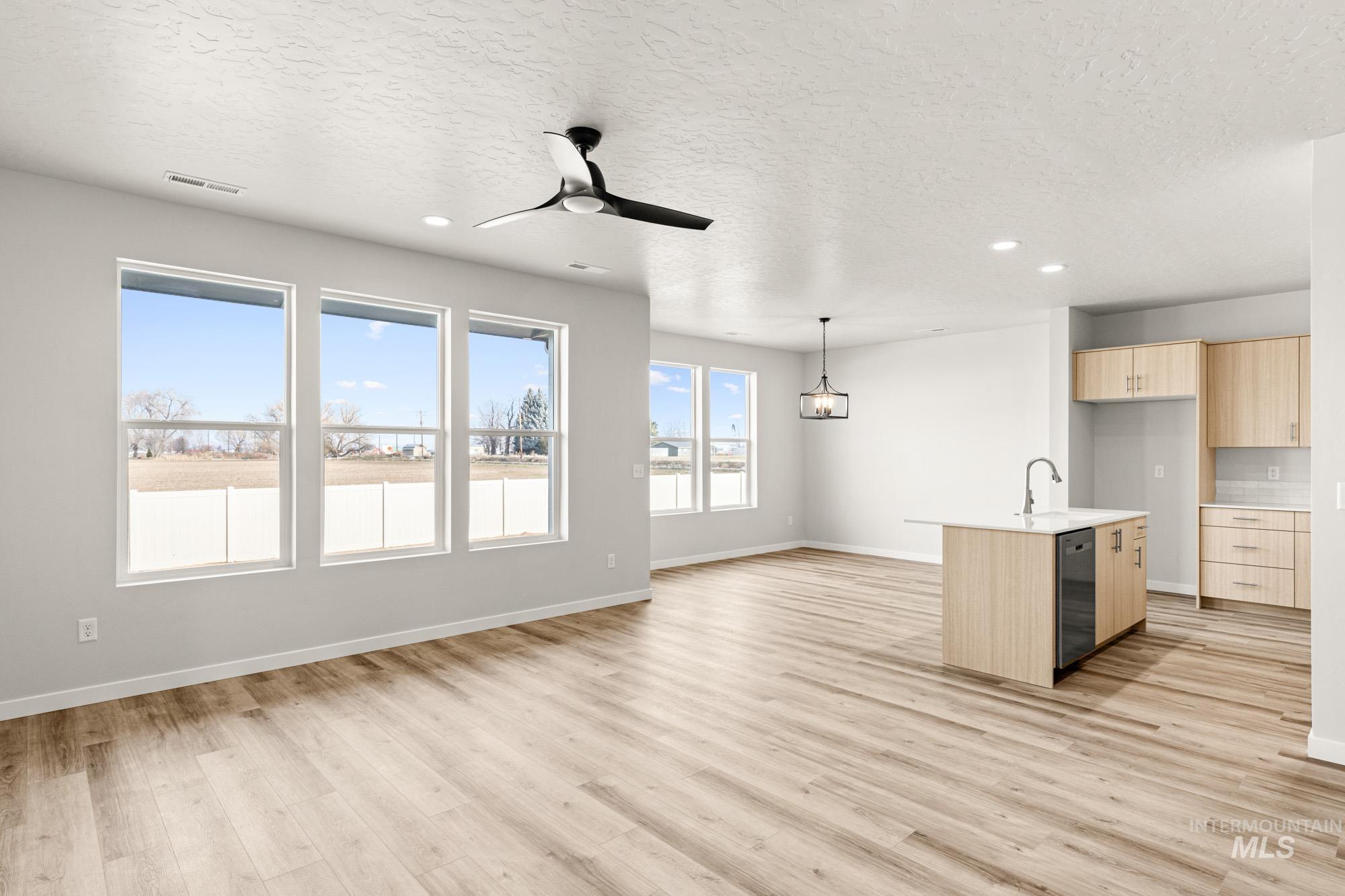 12865 Decatur Street Nampa, ID 83651 - Photo 11 of 20 Open-concept living space featuring wood-finish flooring, recessed lighting, and a contemporary ceiling fan