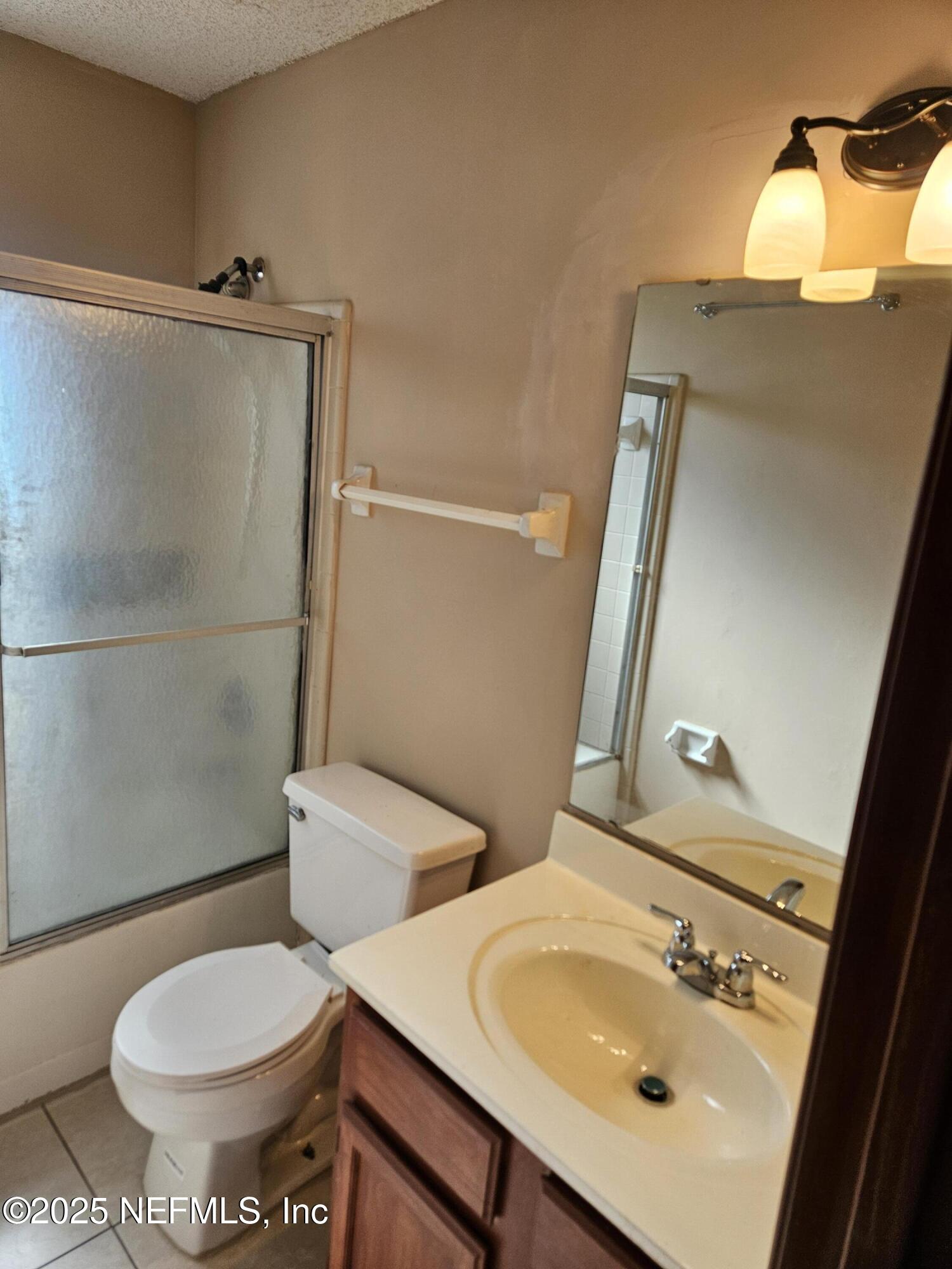 8256 Justin Road North Jacksonville, FL 32210 - Photo 12 of 35 a bathroom with a sink mirror vanity and toilet