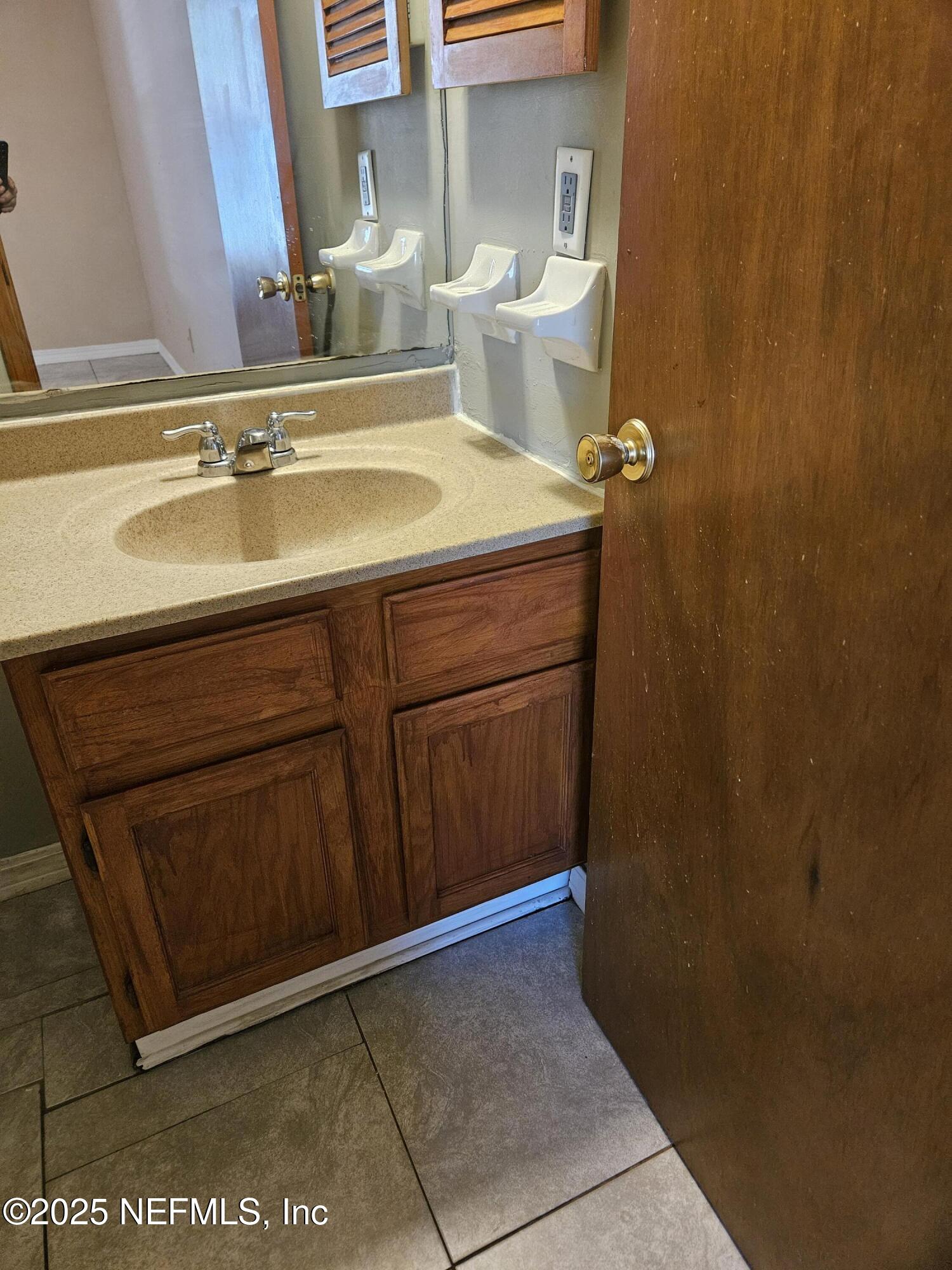 8256 Justin Road North Jacksonville, FL 32210 - Photo 14 of 35 a bathroom with a sink and a mirror