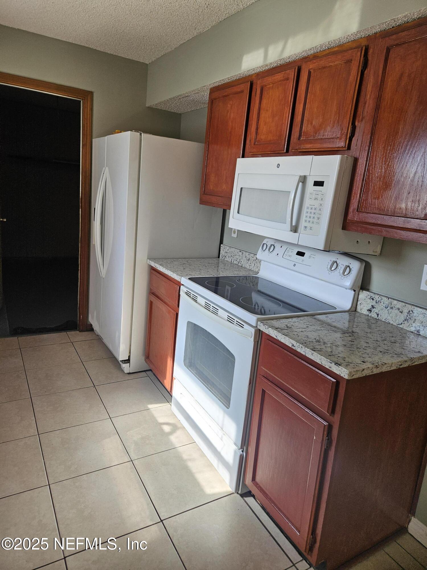 8256 Justin Road North Jacksonville, FL 32210 - Photo 16 of 35 a kitchen with stainless steel appliances granite countertop a refrigerator a sink and dishwasher