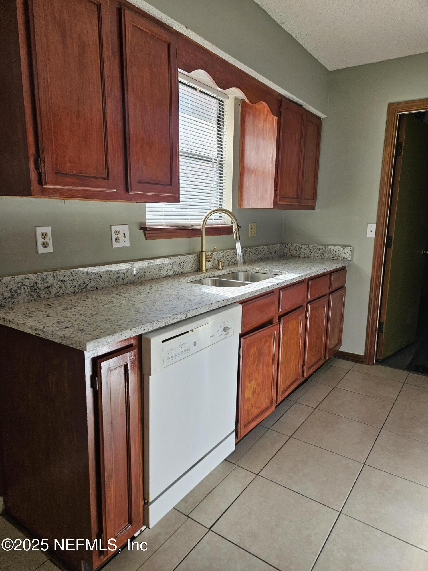 8256 Justin Road North Jacksonville, FL 32210 - Photo 22 of 35 a kitchen with stainless steel appliances granite countertop a sink stove and cabinets