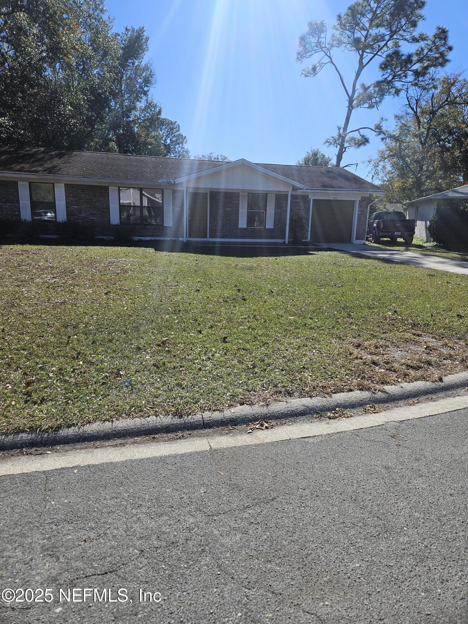 8256 Justin Road North Jacksonville, FL 32210 - Photo 3 of 35 a view of a house with a yard