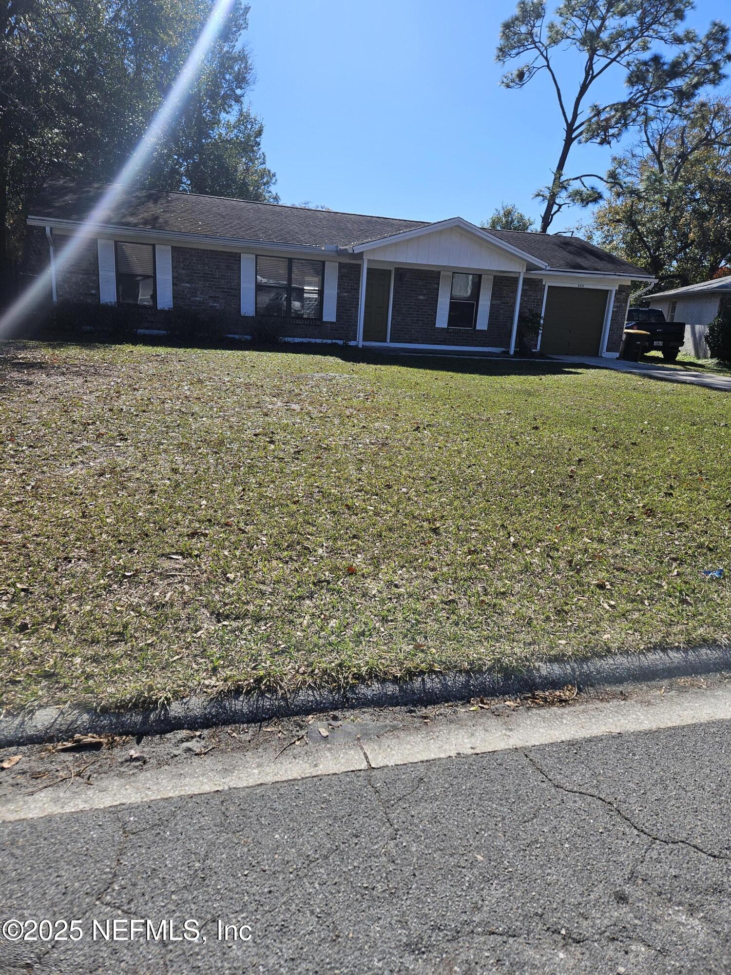 8256 Justin Road North Jacksonville, FL 32210 - Photo 4 of 35 a view of a house with a yard