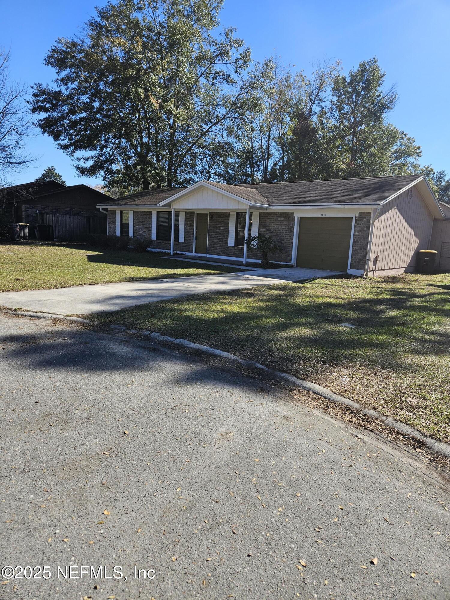 8256 Justin Road North Jacksonville, FL 32210 - Photo 5 of 35 a front view of a house with a yard