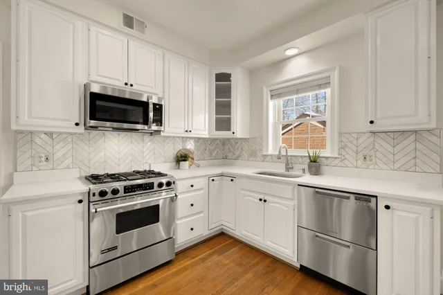 a living room with furniture and large windows