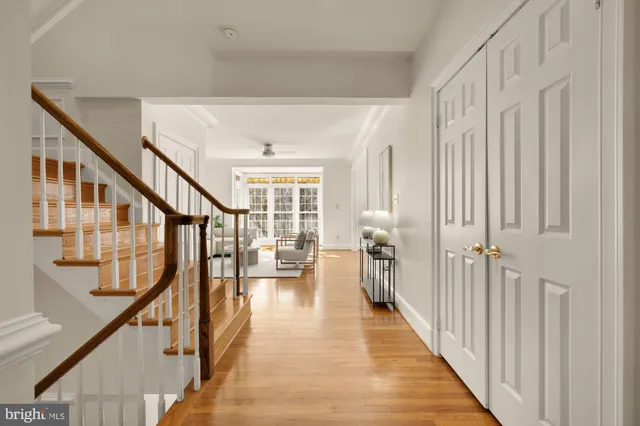 a view of hallway with wooden floor and stairs