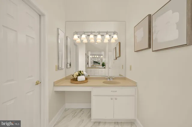 an empty room with chandelier fan