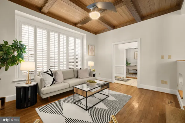 a kitchen with stainless steel appliances a stove a sink a microwave a dining table and chairs