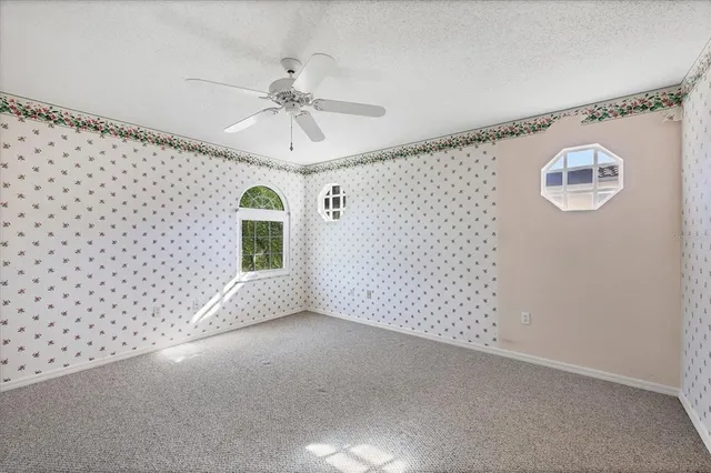 a front view of a house with a yard and potted plants