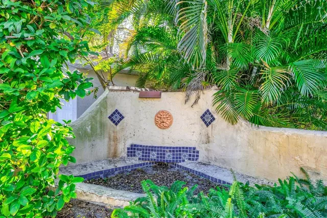 an aerial view of a city with lots of residential buildings ocean and mountain view in back