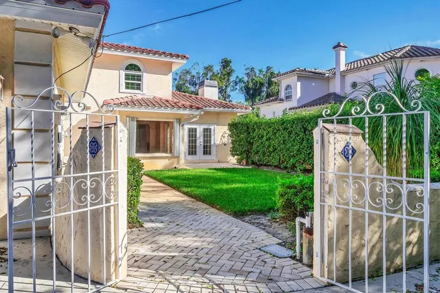 an aerial view of a house with a garden and swimming pool