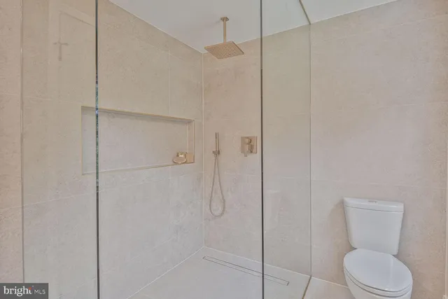 a bathroom with a toilet and a shower