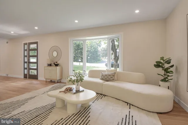 a living room with furniture and a large window