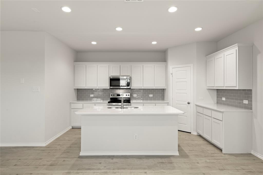 1715 Teton River Drive Blue Ridge, TX 75424 - Photo 14 of 28 a kitchen with stainless steel appliances granite countertop a sink a stove a refrigerator and white cabinets