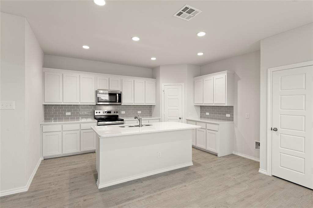 1715 Teton River Drive Blue Ridge, TX 75424 - Photo 15 of 28 a kitchen with cabinets and white appliances