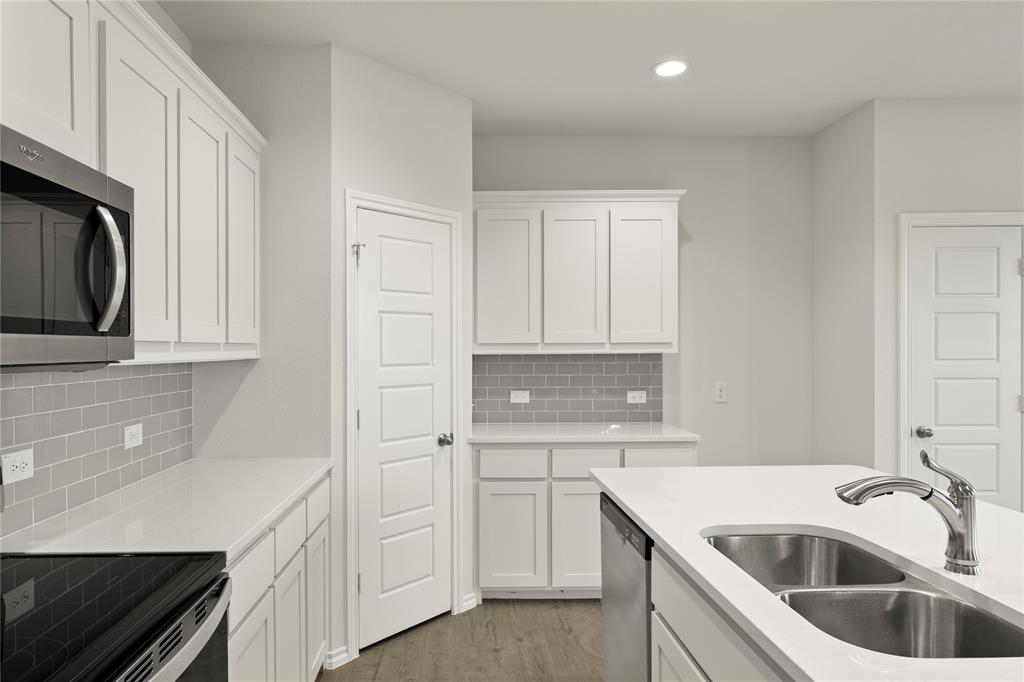 1715 Teton River Drive Blue Ridge, TX 75424 - Photo 16 of 28 a kitchen with white cabinets sink and dishwasher