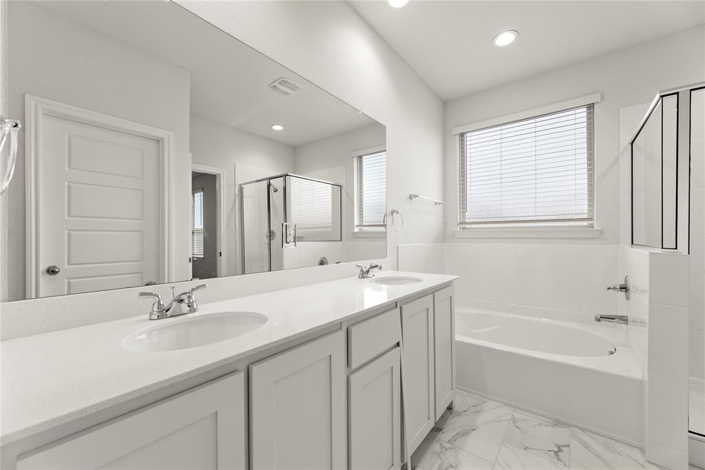 1715 Teton River Drive Blue Ridge, TX 75424 - Photo 23 of 28 a bathroom with a sink double vanity granite tub shower and a mirror