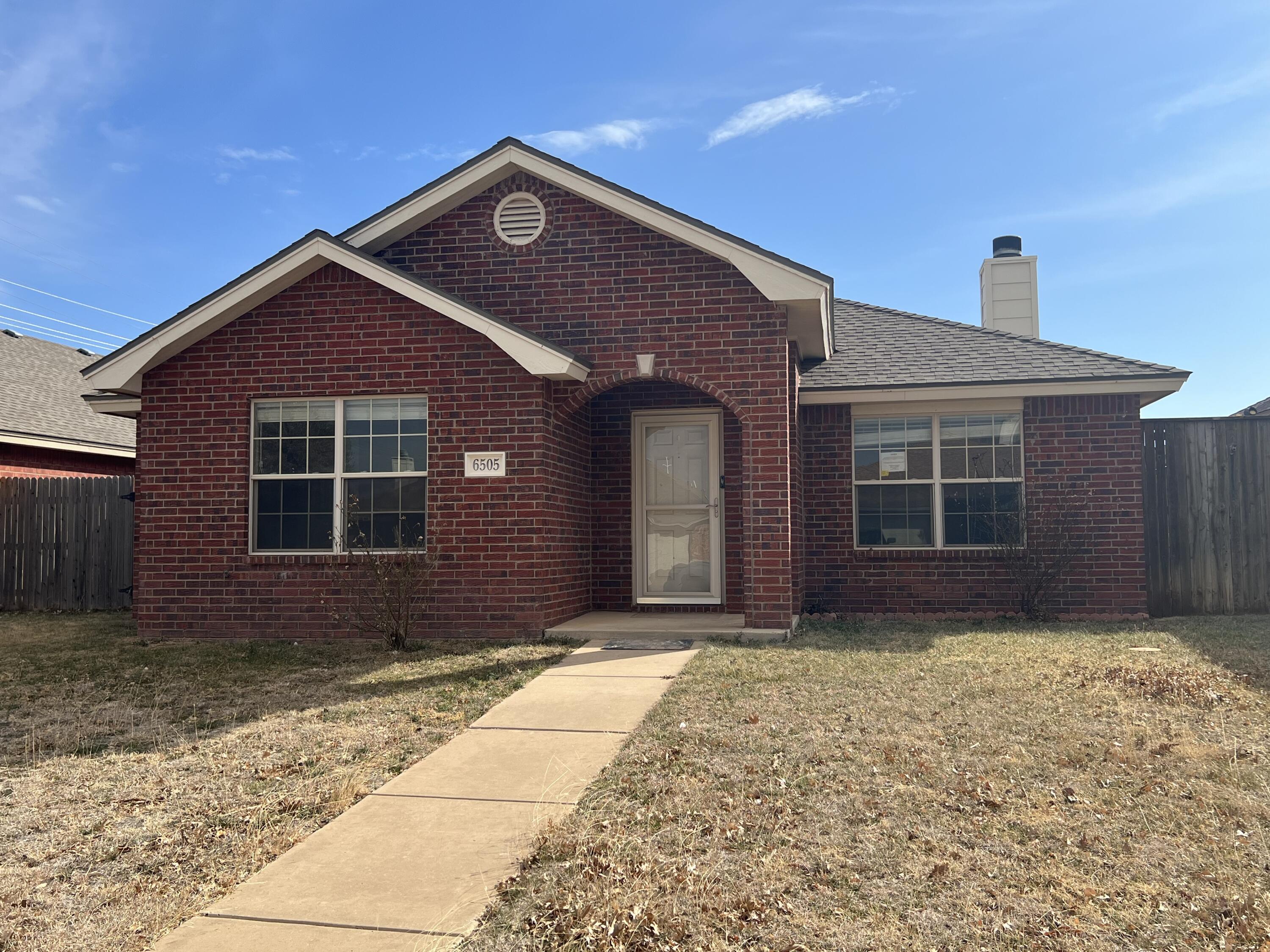6505 8th Street Lubbock, TX 79416 - Photo 1 of 12 a front view of a house with a yard