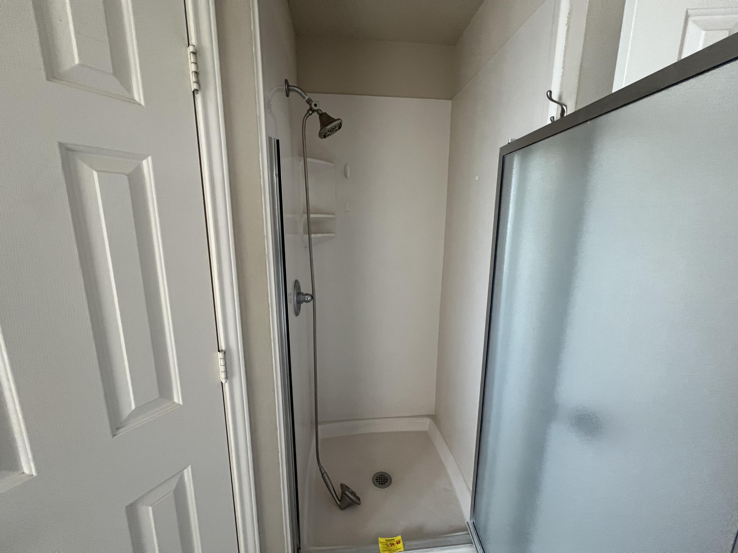 6505 8th Street Lubbock, TX 79416 - Photo 8 of 12 a bathroom with a glass shower door and sink