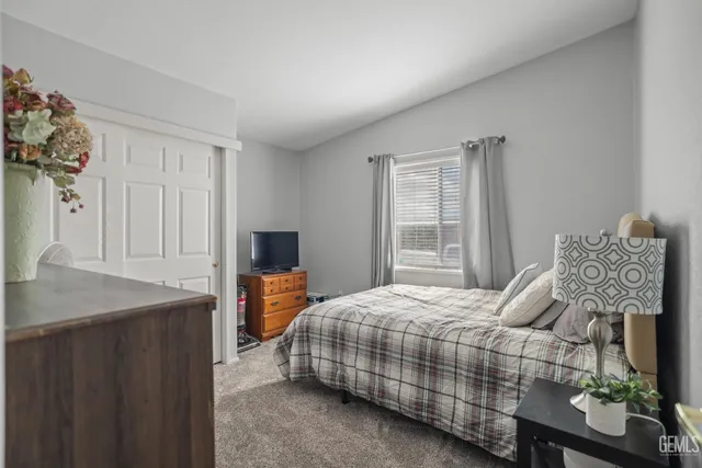 a bedroom with a bed and dresser