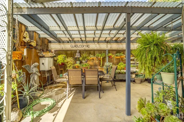 a view of a porch with chairs and floor to ceiling window