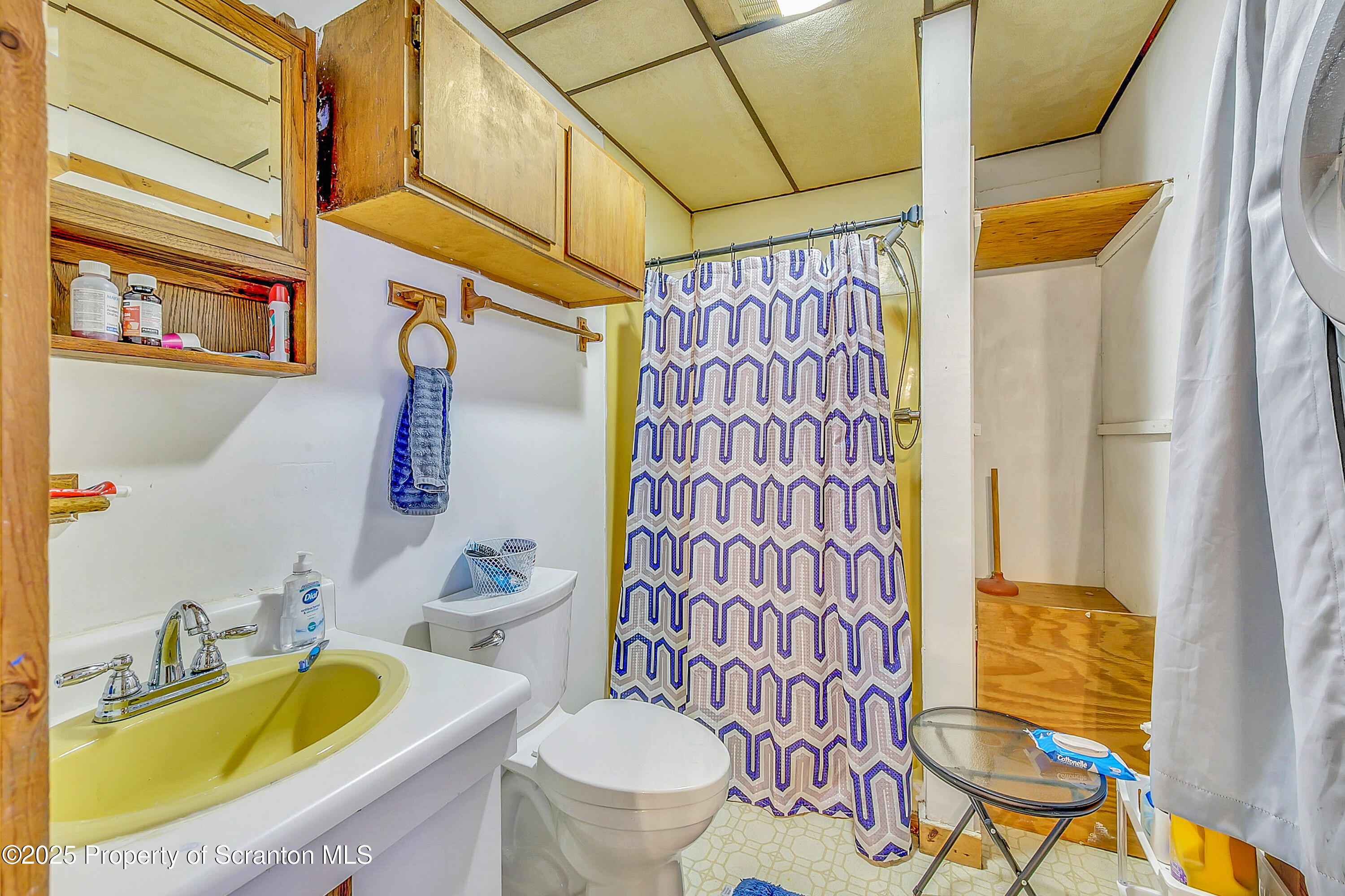 807 Columbus Avenue Blakely, PA 18447 - Photo 20 of 37 a bathroom with a granite countertop toilet sink and a shower curtain
