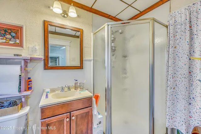 a bathroom with a sink toilet and shower