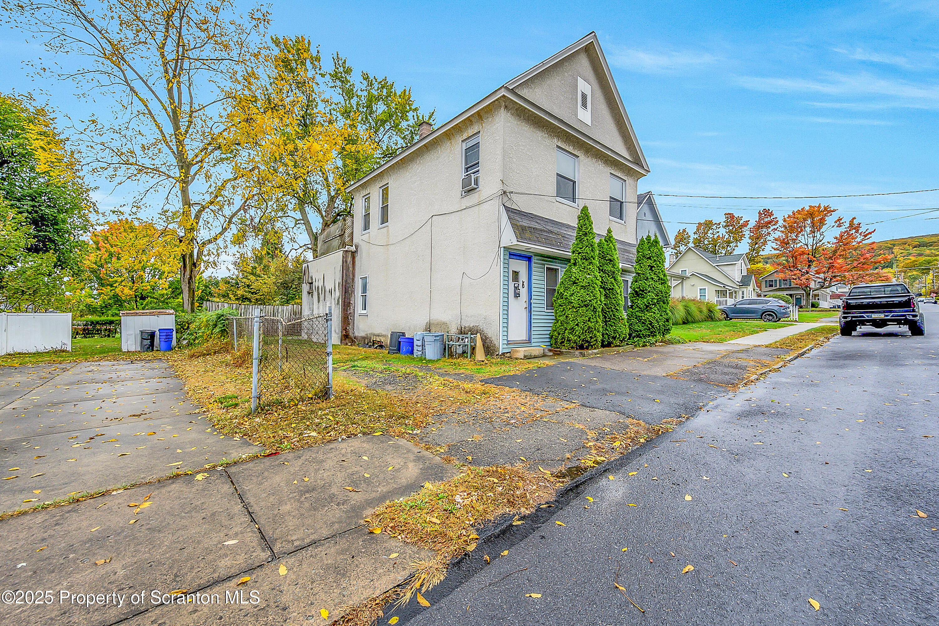 807 Columbus Avenue Blakely, PA 18447 - Photo 3 of 37 a view of a white house with a yard and road