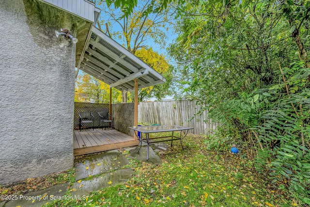 a backyard of a house with table and chairs