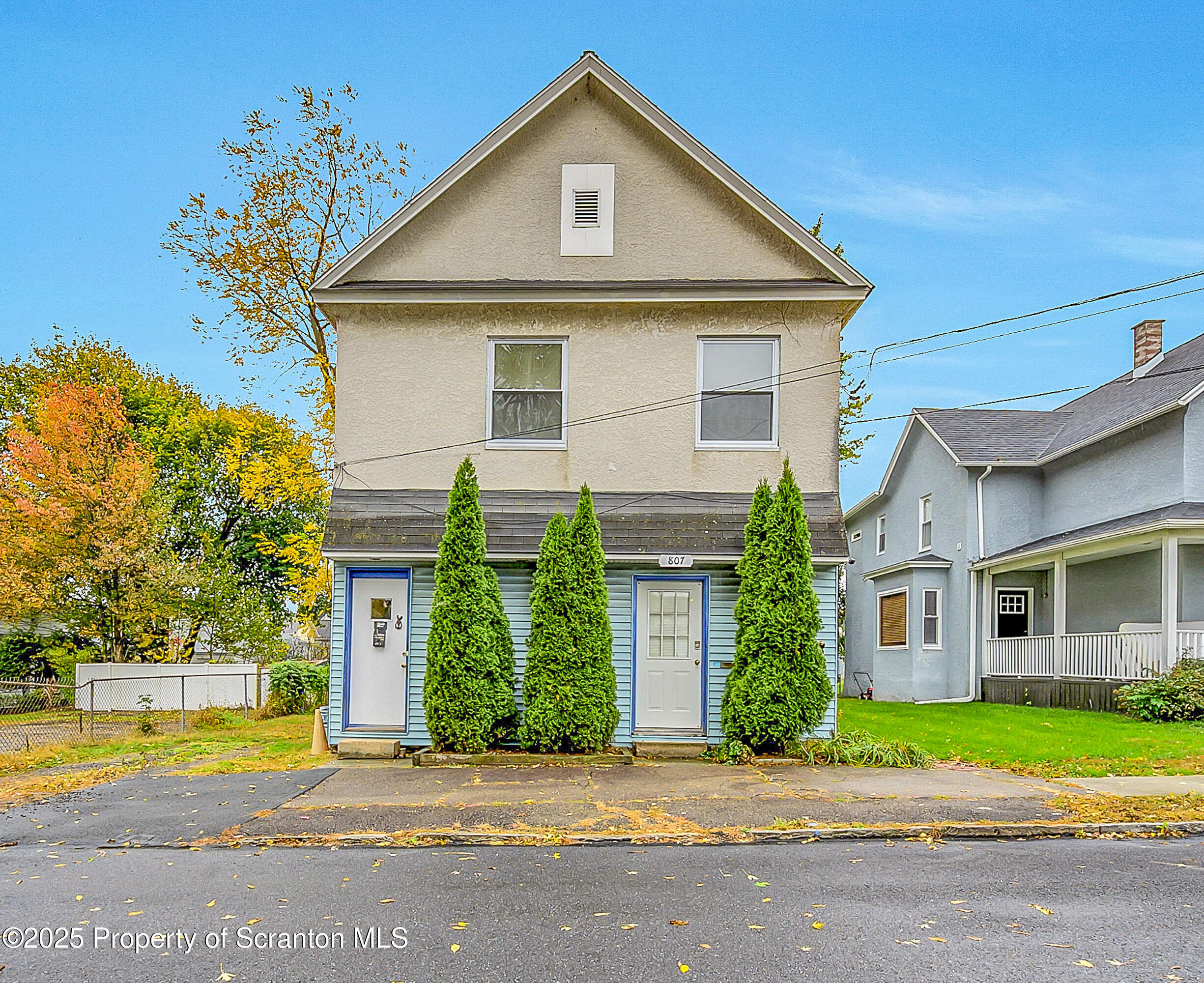 807 Columbus Avenue Blakely, PA 18447 - Photo 9 of 37 a front view of a house with a yard and garage