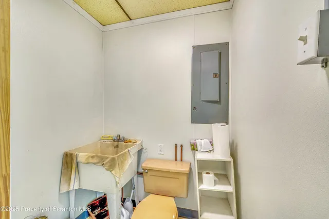 a bathroom with a toilet sink and mirror