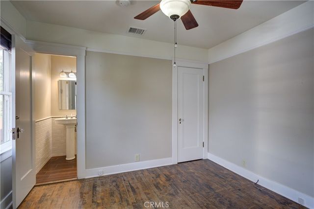 a view of an empty room with a ceiling fan