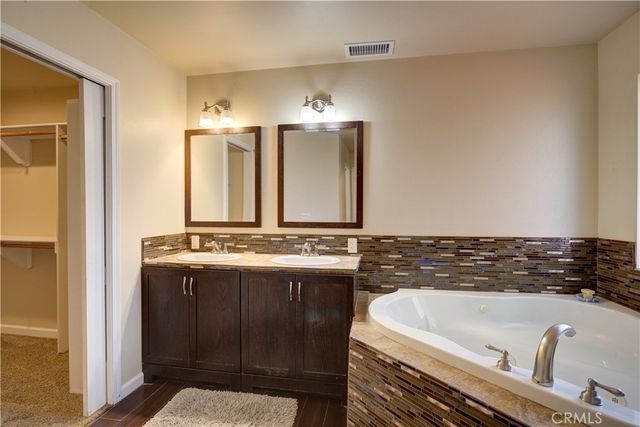 a bathroom with a bathtub and a sink