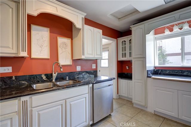 a kitchen with stainless steel appliances granite countertop a sink and a stove