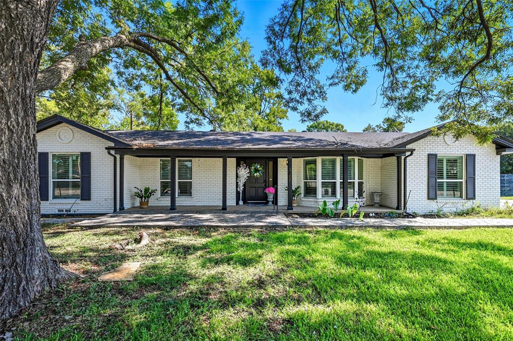 5100 Murphy Road Sachse, TX 75048 - Photo 1 of 38 a front view of a house with a yard table and chairs