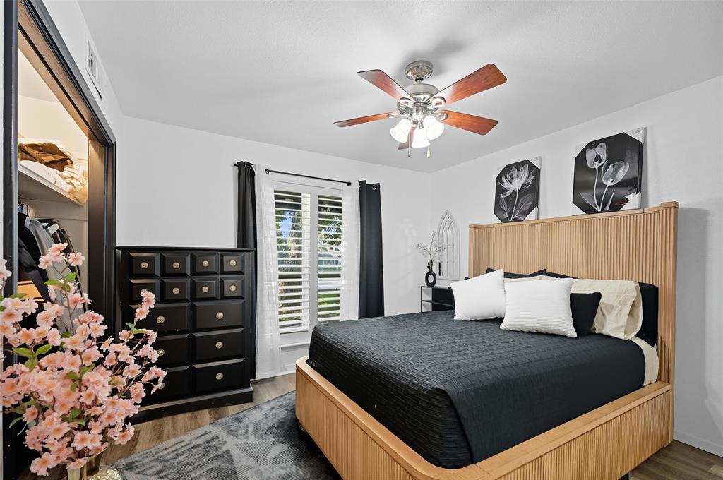 5100 Murphy Road Sachse, TX 75048 - Photo 11 of 38 a bedroom with a large bed and a chandelier