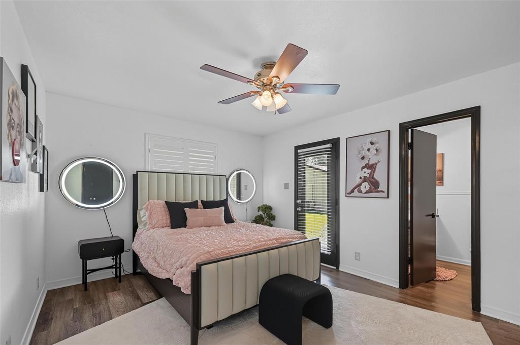 5100 Murphy Road Sachse, TX 75048 - Photo 13 of 38 a bedroom with a bed a clock and a chandelier