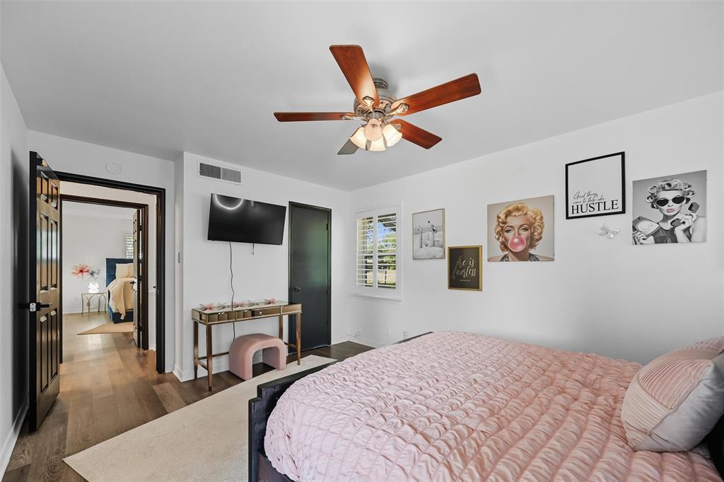 5100 Murphy Road Sachse, TX 75048 - Photo 14 of 38 a bedroom with a bed and a chandelier