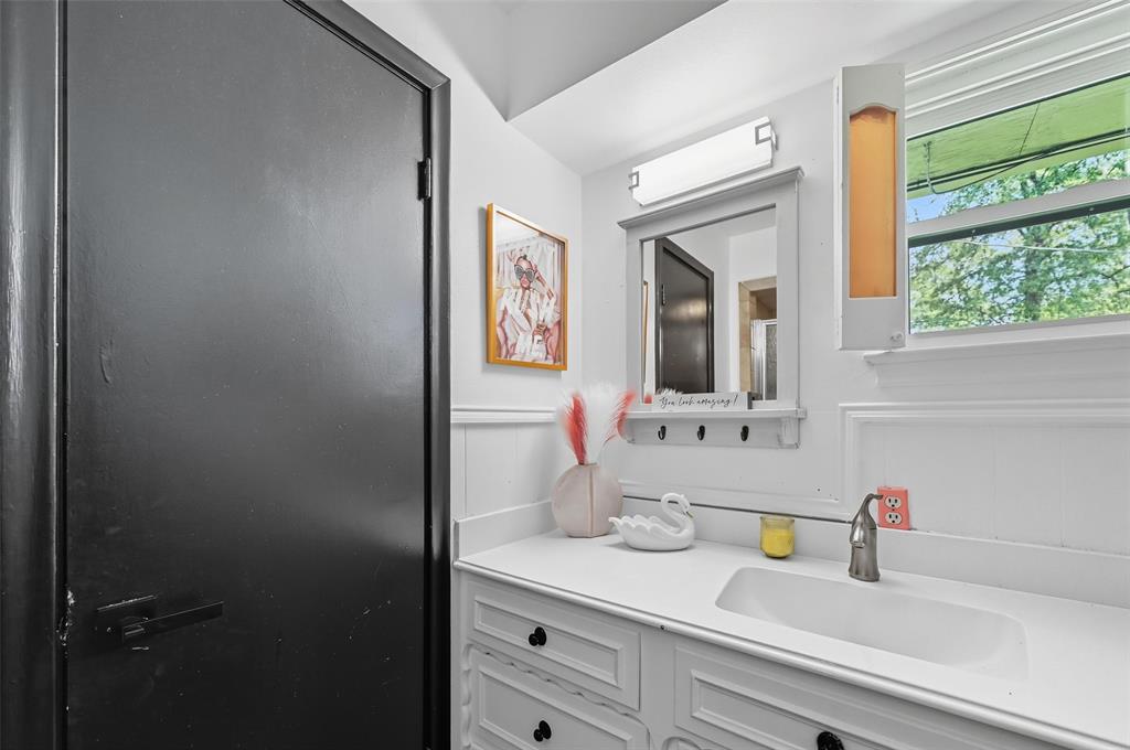5100 Murphy Road Sachse, TX 75048 - Photo 15 of 38 a bathroom with a sink and a mirror