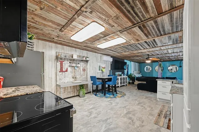 a kitchen with furniture a counter top space stainless steel appliances and a dining table