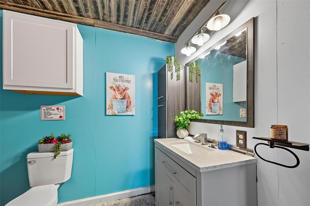 5100 Murphy Road Sachse, TX 75048 - Photo 21 of 38 a bathroom with a sink mirror vanity and toilet