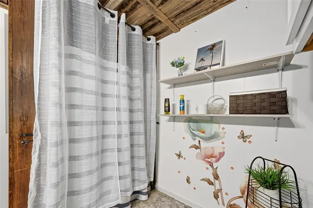 a living room with stainless steel appliances granite countertop furniture and a table