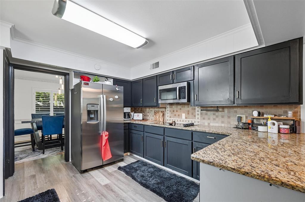 5100 Murphy Road Sachse, TX 75048 - Photo 7 of 38 a kitchen with stainless steel appliances granite countertop a sink stove and refrigerator