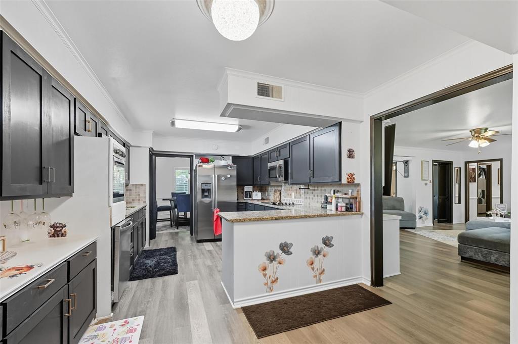5100 Murphy Road Sachse, TX 75048 - Photo 36 of 38 a kitchen with stainless steel appliances granite countertop a sink stove and refrigerator