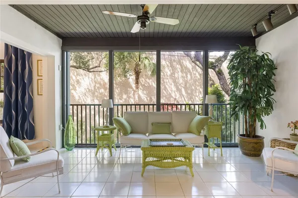 a living room with furniture and a large window with outer view