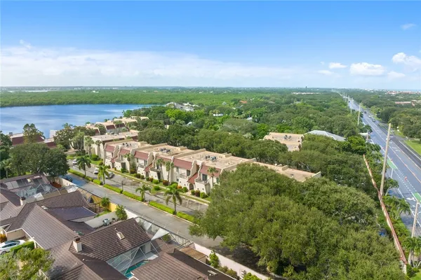 an aerial view of a city with lots of residential buildings and ocean view