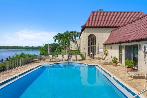 a view of a house with a swimming pool and sitting area
